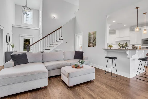 a living room with furniture and wooden floor