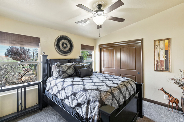 210 Talon Court Ivins, UT 84738 - Photo 37 of 60 Bedroom with a closet, lofted ceiling, ceiling fan, and dark carpet