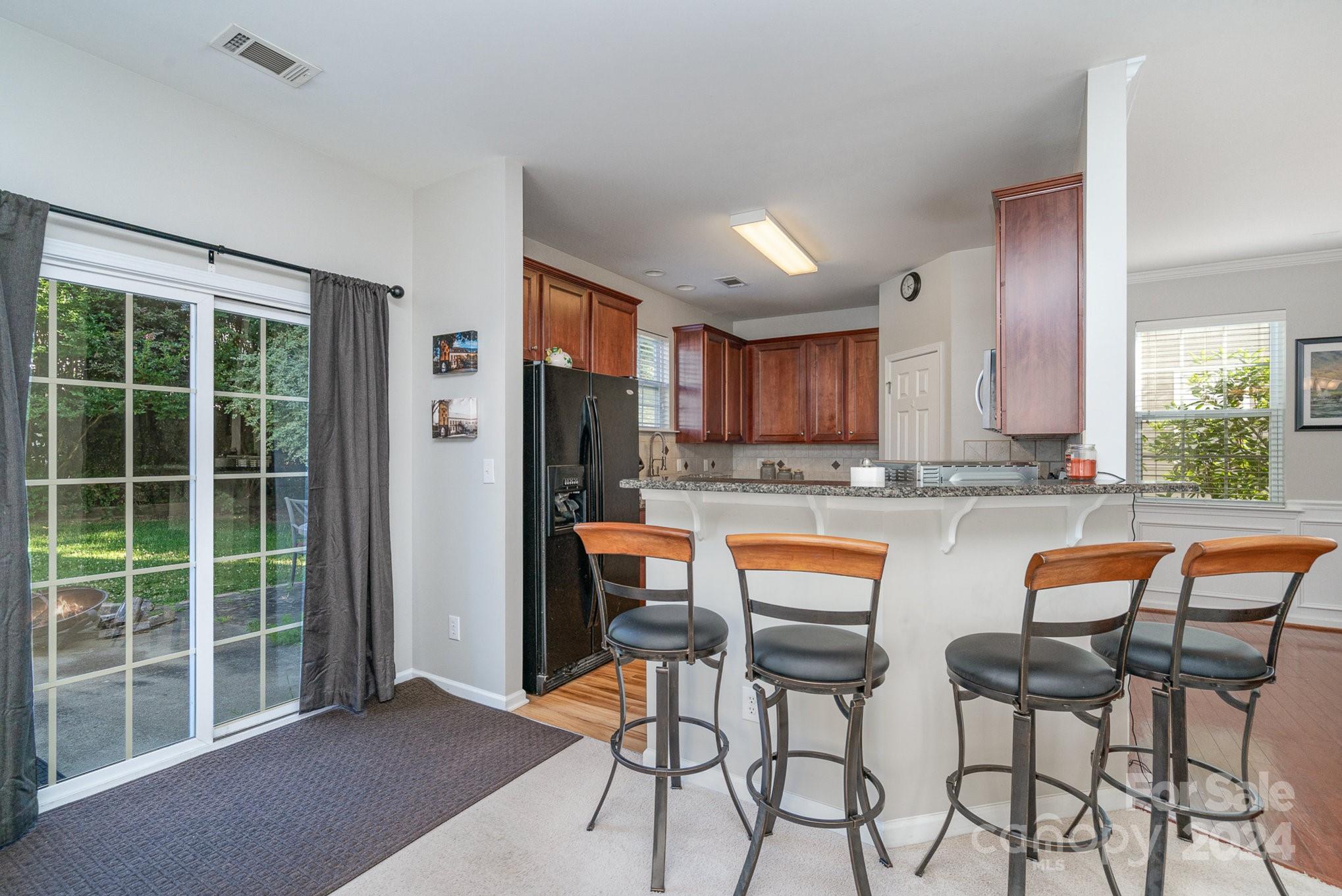 3367 Streamside Drive Davidson, NC 28036 - Photo 11 of 35 a kitchen with stainless steel appliances granite countertop a refrigerator and a chair
