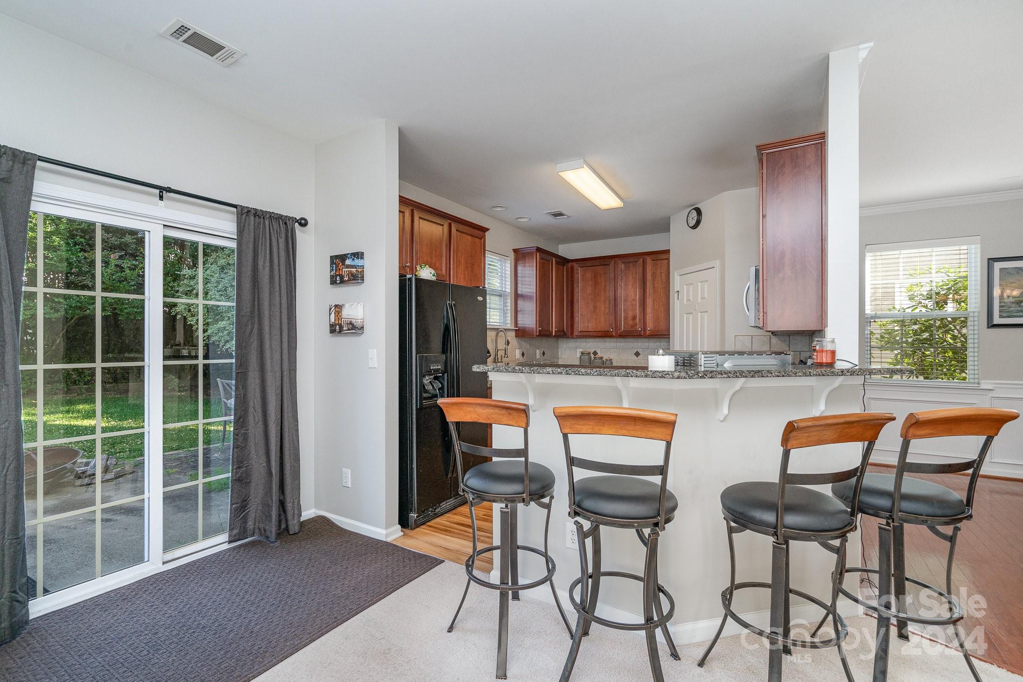 3367 Streamside Drive Davidson, NC 28036 - Photo 12 of 35 a kitchen with stainless steel appliances granite countertop a refrigerator and a chair