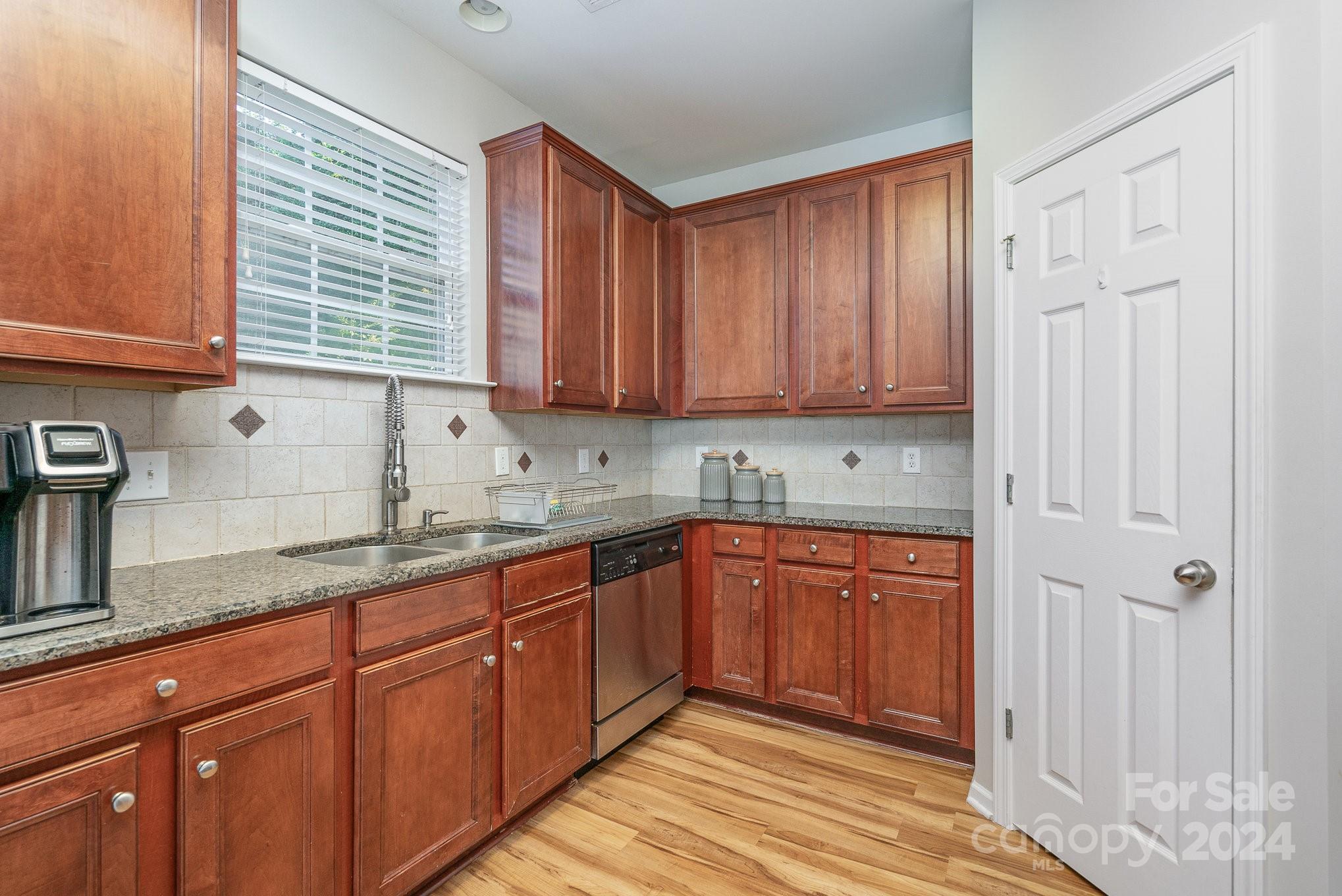 3367 Streamside Drive Davidson, NC 28036 - Photo 13 of 35 a kitchen with stainless steel appliances granite countertop wooden cabinets a sink and dishwasher