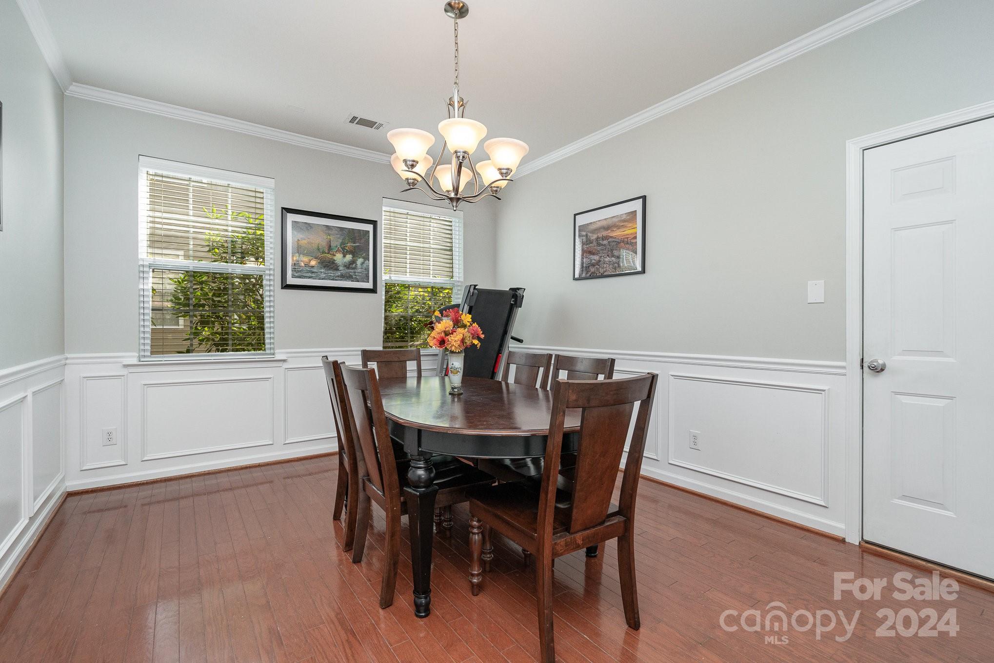 3367 Streamside Drive Davidson, NC 28036 - Photo 16 of 35 a view of a dining room with furniture a chandelier and wooden floor