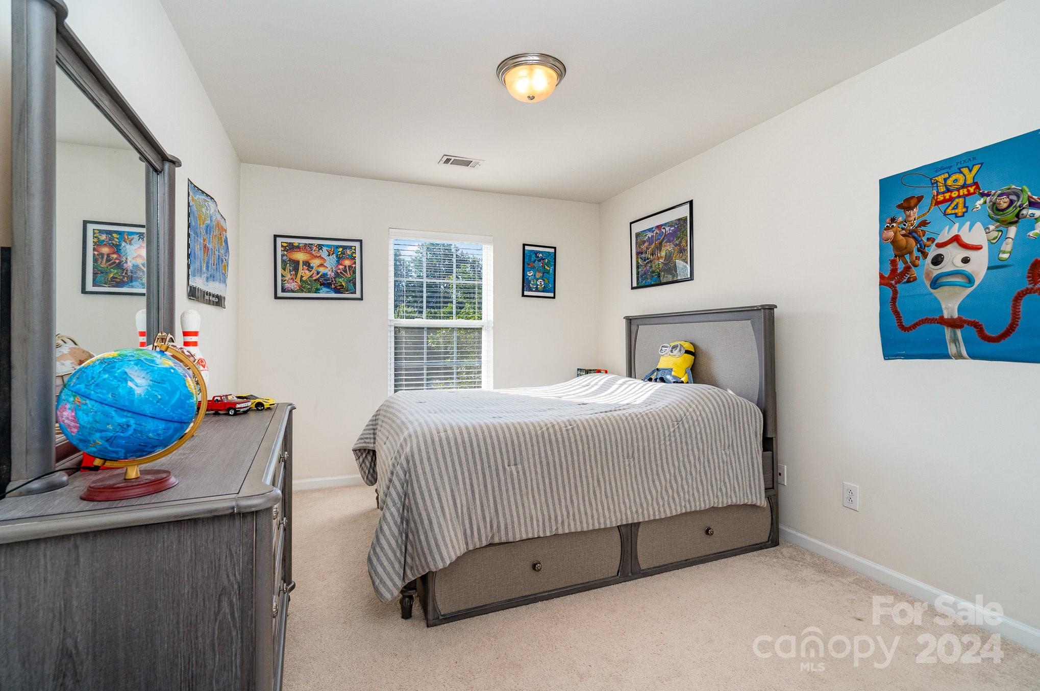 3367 Streamside Drive Davidson, NC 28036 - Photo 18 of 35 a bedroom with a bed and cabinets
