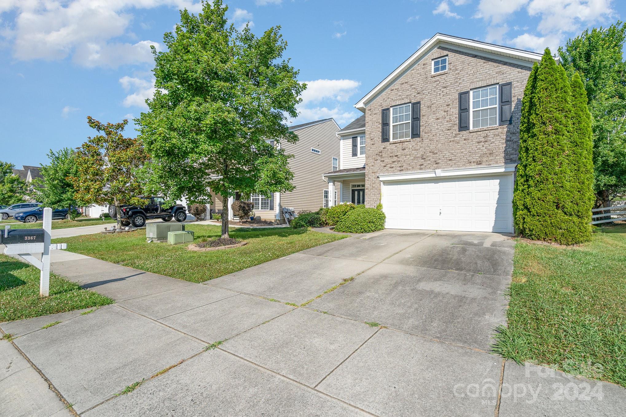 3367 Streamside Drive Davidson, NC 28036 - Photo 2 of 35 a front view of a house with a yard and garage
