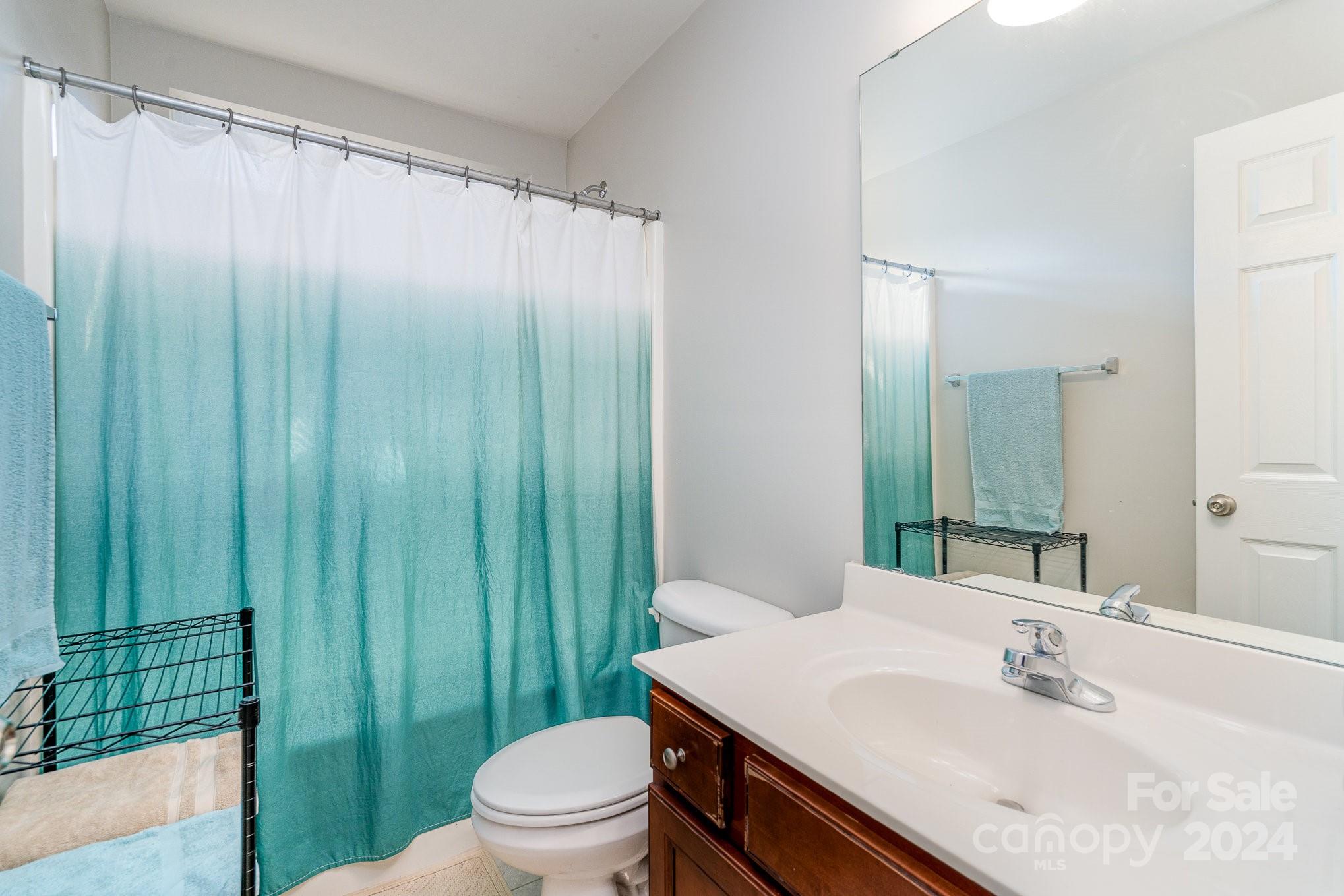 3367 Streamside Drive Davidson, NC 28036 - Photo 22 of 35 a bathroom with a sink a toilet and shower