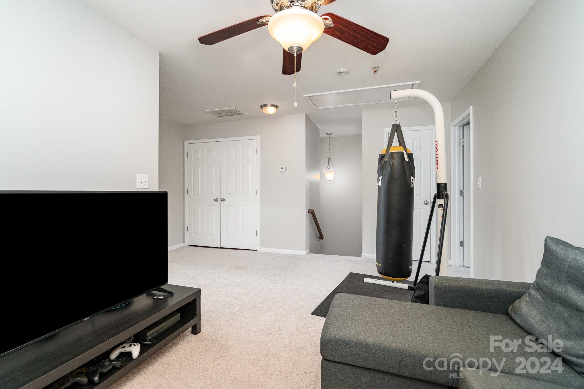 3367 Streamside Drive Davidson, NC 28036 - Photo 24 of 35 a living room with furniture and a flat screen tv