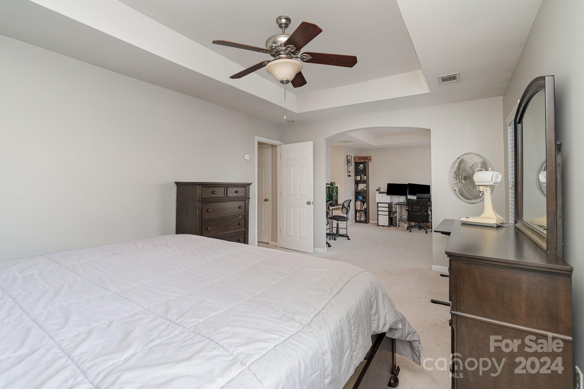 3367 Streamside Drive Davidson, NC 28036 - Photo 26 of 35 a bedroom with a bed and dresser with mirror