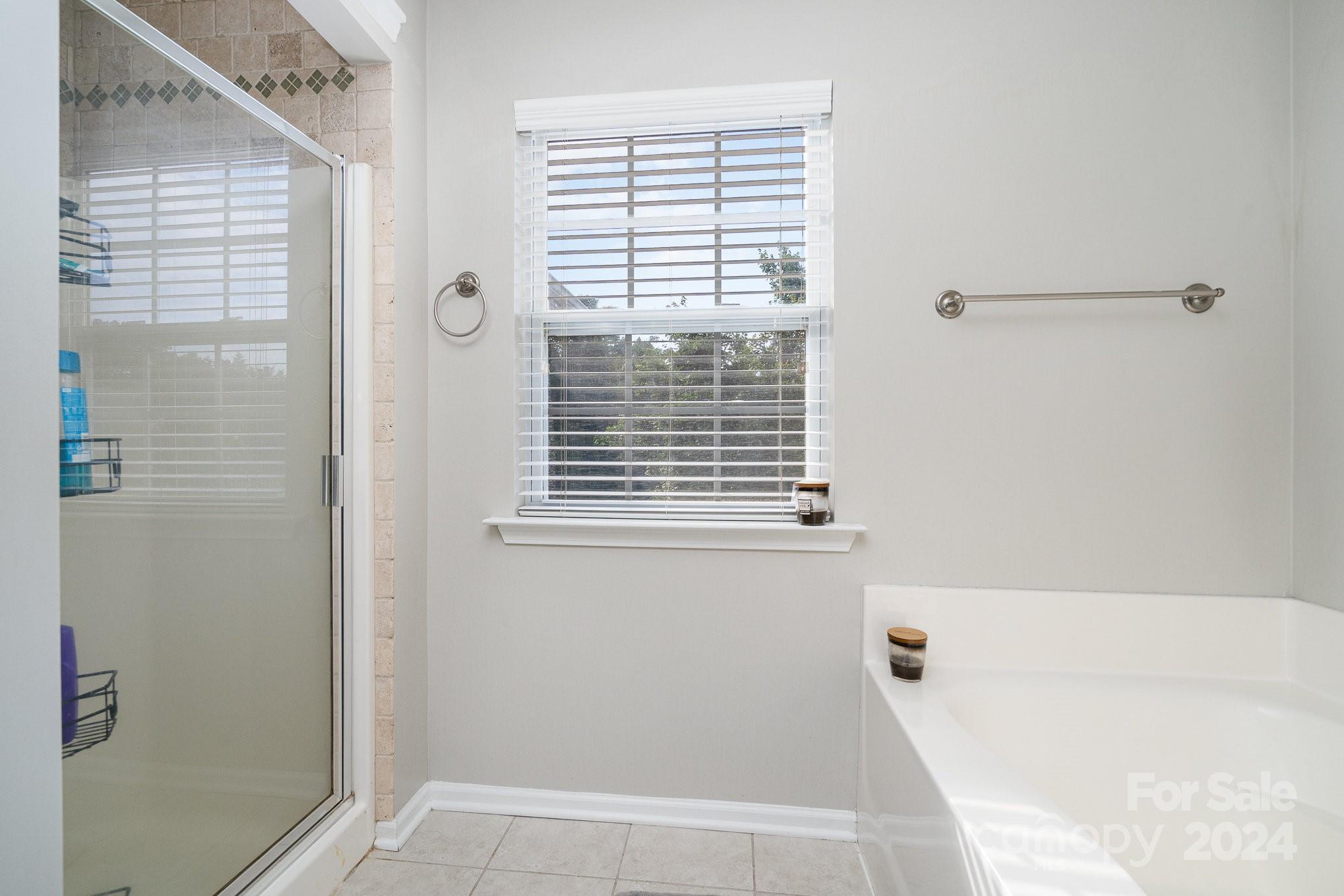 3367 Streamside Drive Davidson, NC 28036 - Photo 29 of 35 a bathroom with a bathtub and a shower