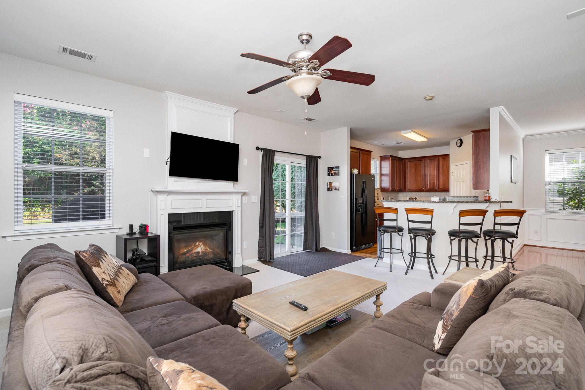 3367 Streamside Drive Davidson, NC 28036 - Photo 9 of 35 a living room with furniture kitchen view and a fireplace