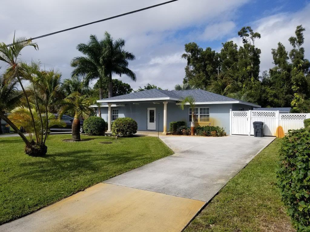 2855 Floral Road Lake Worth, FL 33462 - Photo 4 of 19 front view of a house with a yard