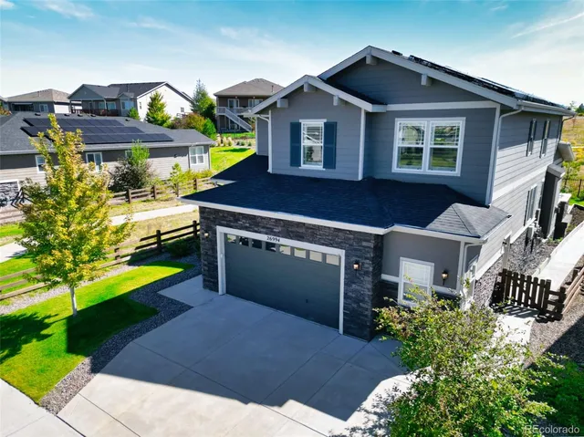 a front view of a house with a yard and potted plants