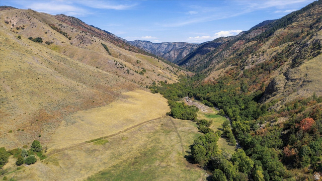 3105 East Canyon Road Smithfield, UT 84335 - Photo 6 of 8 Expansive property featuring varied terrain, a valley with mature trees, and distant mountains