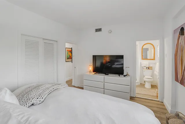 a bedroom with a bed and a flat screen tv