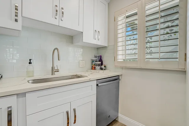 a kitchen with stainless steel appliances a sink and cabinets