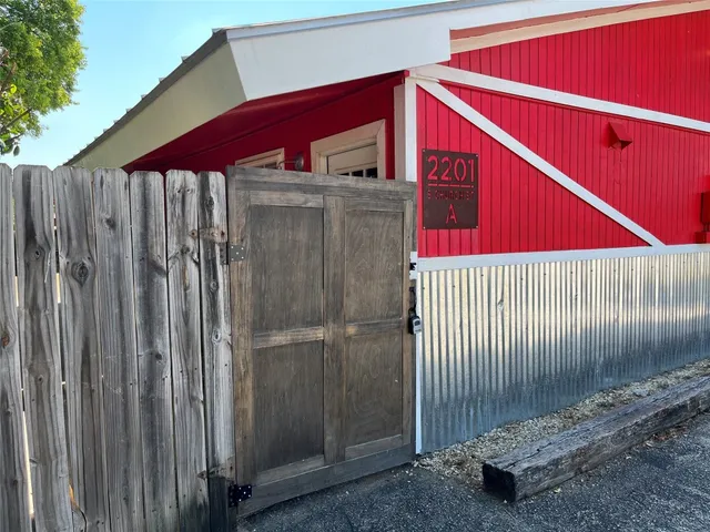 a view of a wooden door with a small yard