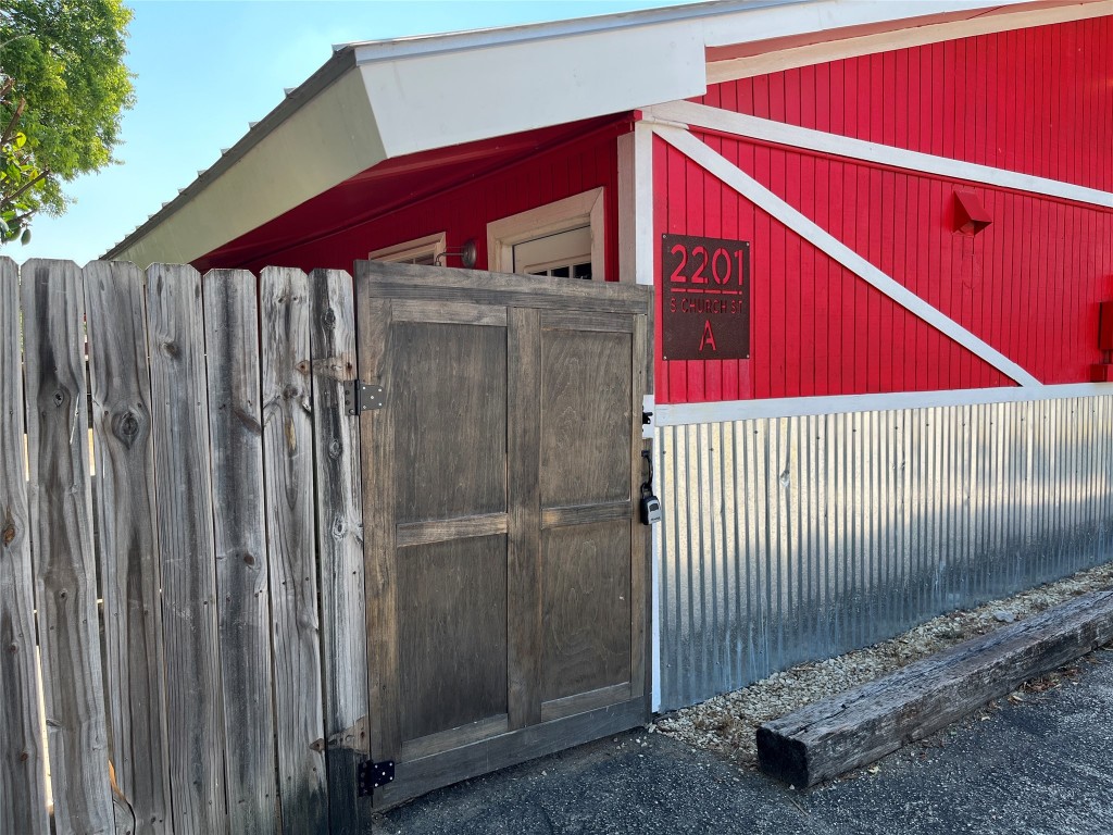 a view of a wooden door with a small yard