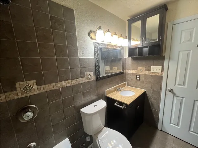 a bathroom with a sink toilet and mirror
