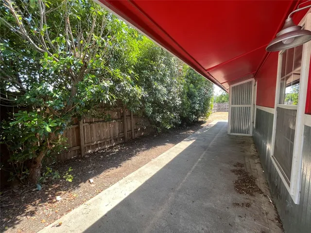 a view of a yard with wooden fence