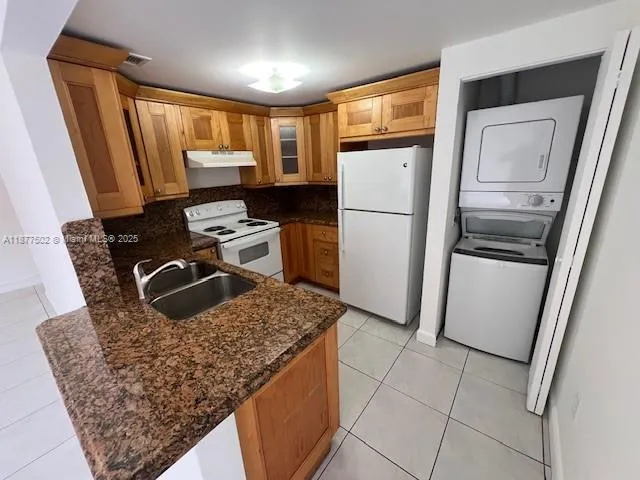a kitchen with stainless steel appliances granite countertop a refrigerator stove and sink