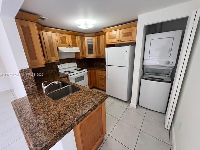 a kitchen with stainless steel appliances granite countertop a refrigerator stove and sink