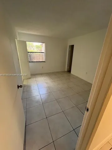 a view of an empty room and a window