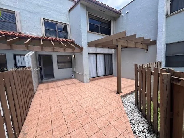 a backyard of a house with wooden fence