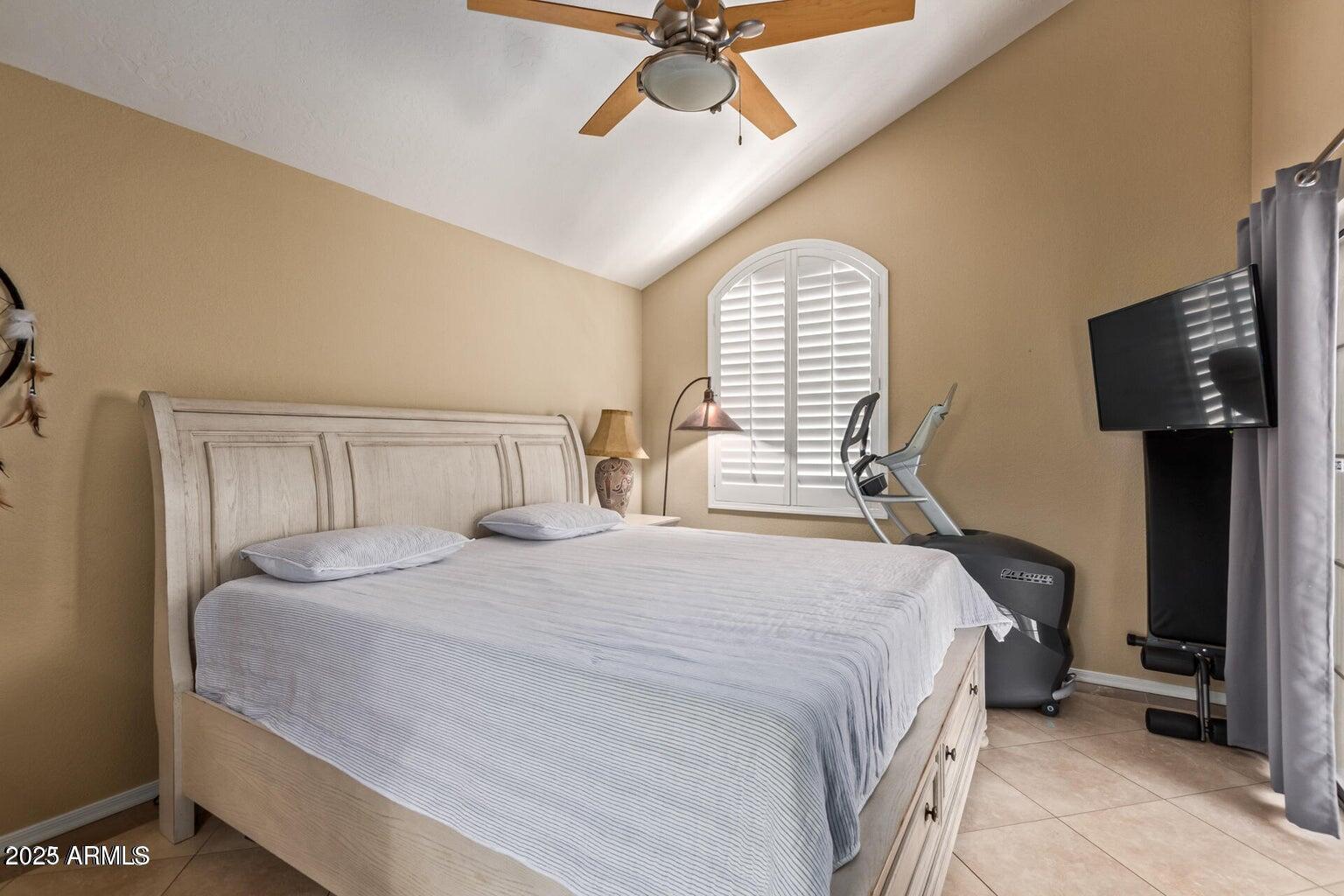 6945 East Cochise Road, Unit 130 Paradise Valley, AZ 85253 - Photo 12 of 24 a bedroom with a bed and a chandelier