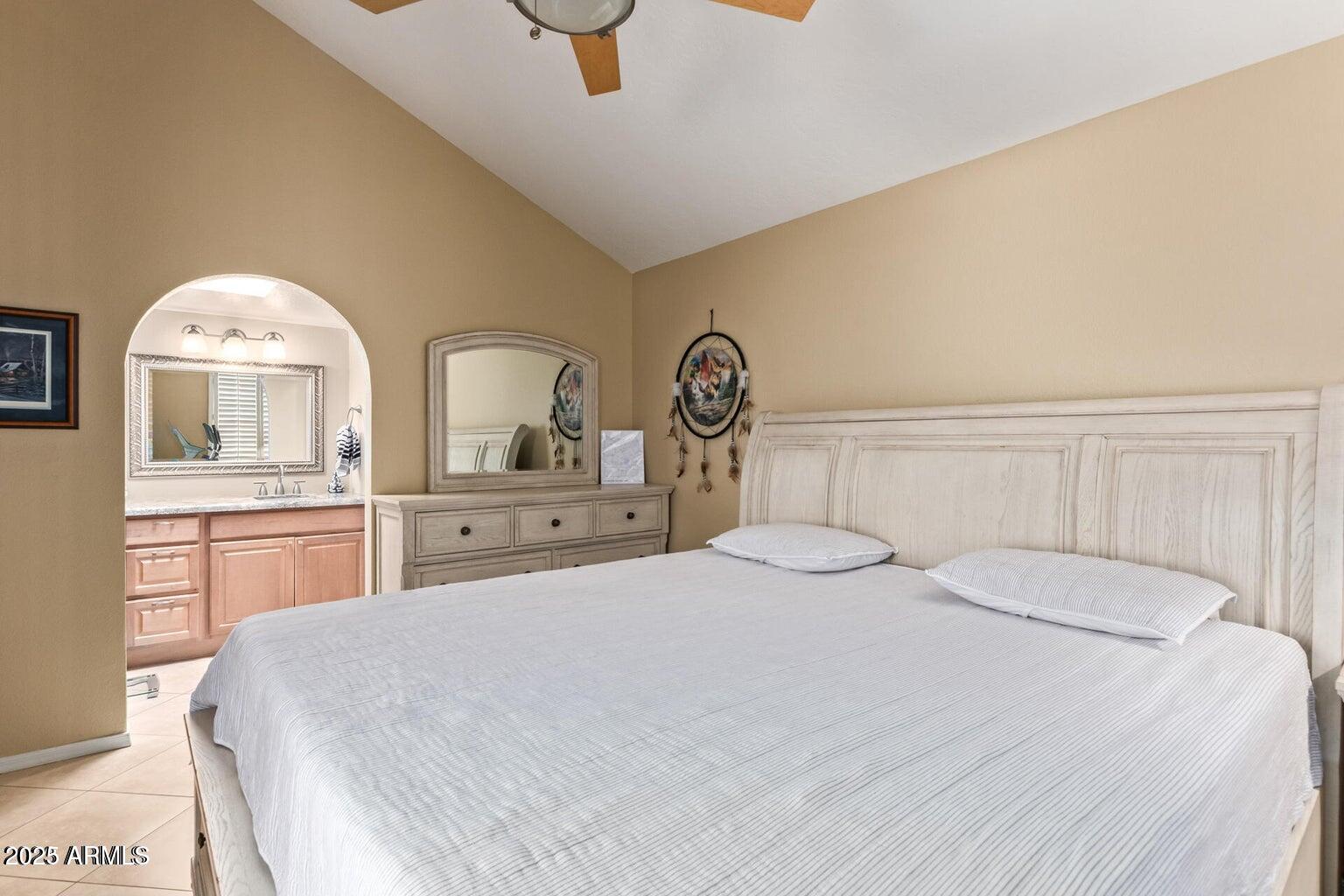 6945 East Cochise Road, Unit 130 Paradise Valley, AZ 85253 - Photo 13 of 24 a bedroom with a bed and a chandelier