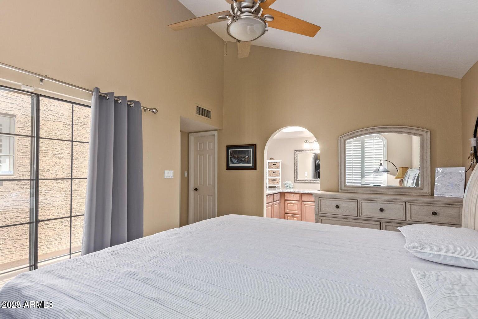 6945 East Cochise Road, Unit 130 Paradise Valley, AZ 85253 - Photo 14 of 24 a bedroom with a bed dresser and a window