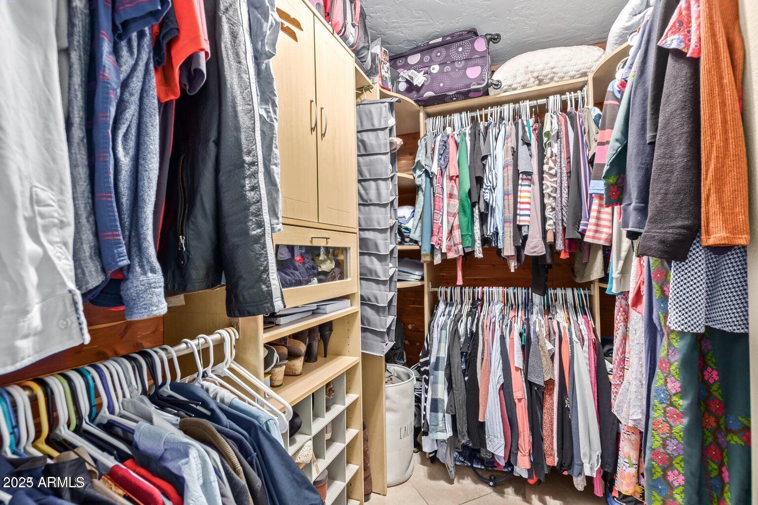 6945 East Cochise Road, Unit 130 Paradise Valley, AZ 85253 - Photo 15 of 24 a view of walk in closet with clothes