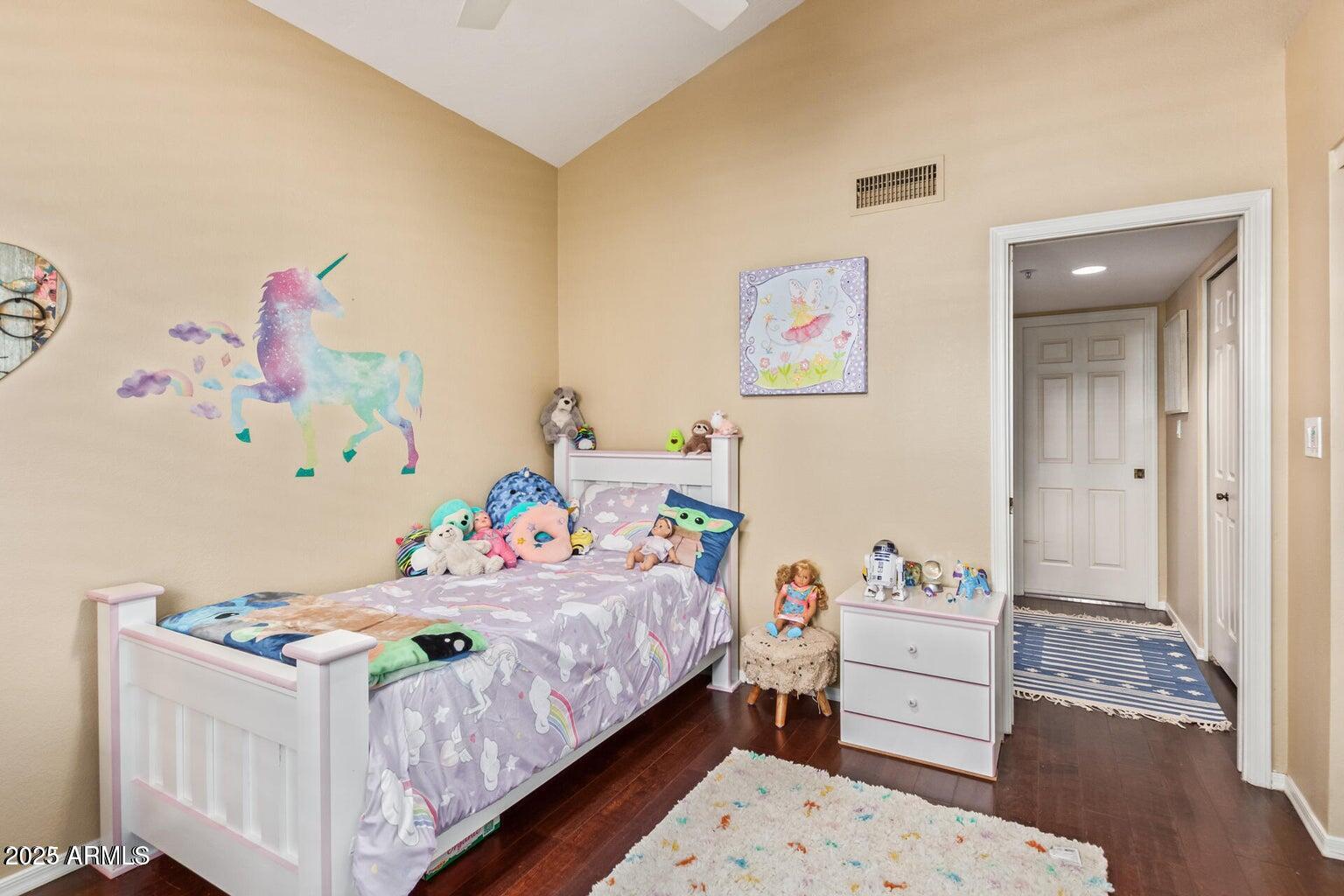 6945 East Cochise Road, Unit 130 Paradise Valley, AZ 85253 - Photo 19 of 24 a bedroom with a bed and wooden floor
