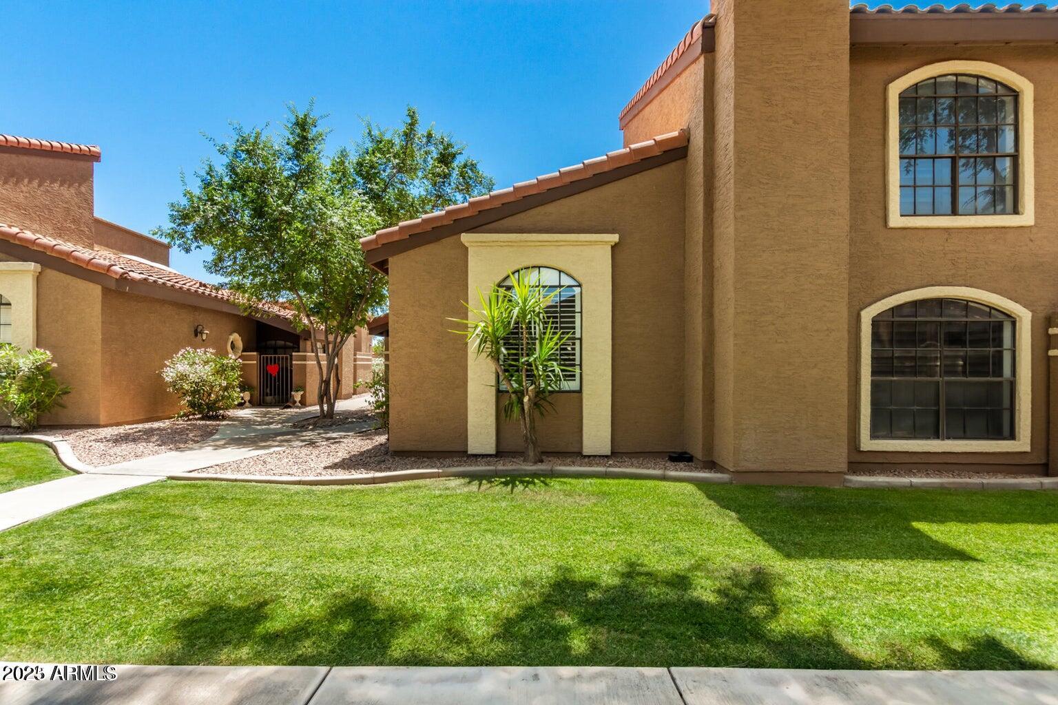 6945 East Cochise Road, Unit 130 Paradise Valley, AZ 85253 - Photo 2 of 24 a front view of a house with garden