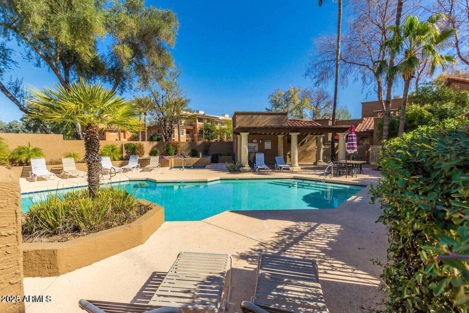 6945 East Cochise Road, Unit 130 Paradise Valley, AZ 85253 - Photo 23 of 24 a view of a house with a yard and potted plants
