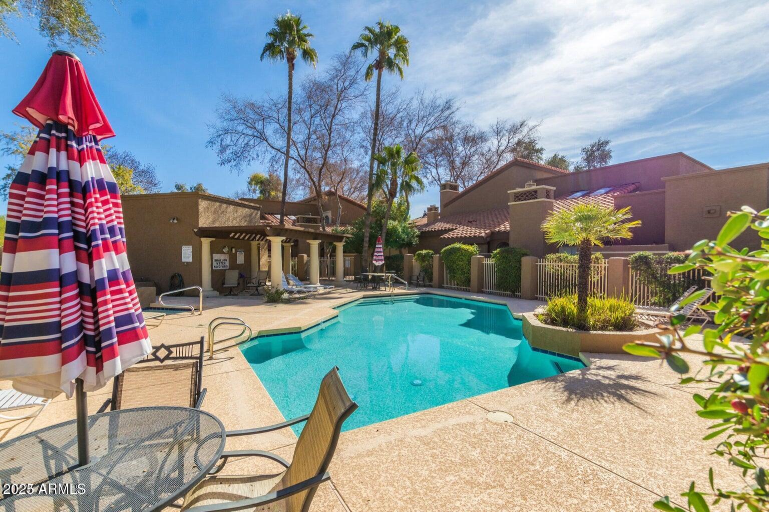 6945 East Cochise Road, Unit 130 Paradise Valley, AZ 85253 - Photo 24 of 24 a view of a house with swimming pool and sitting area