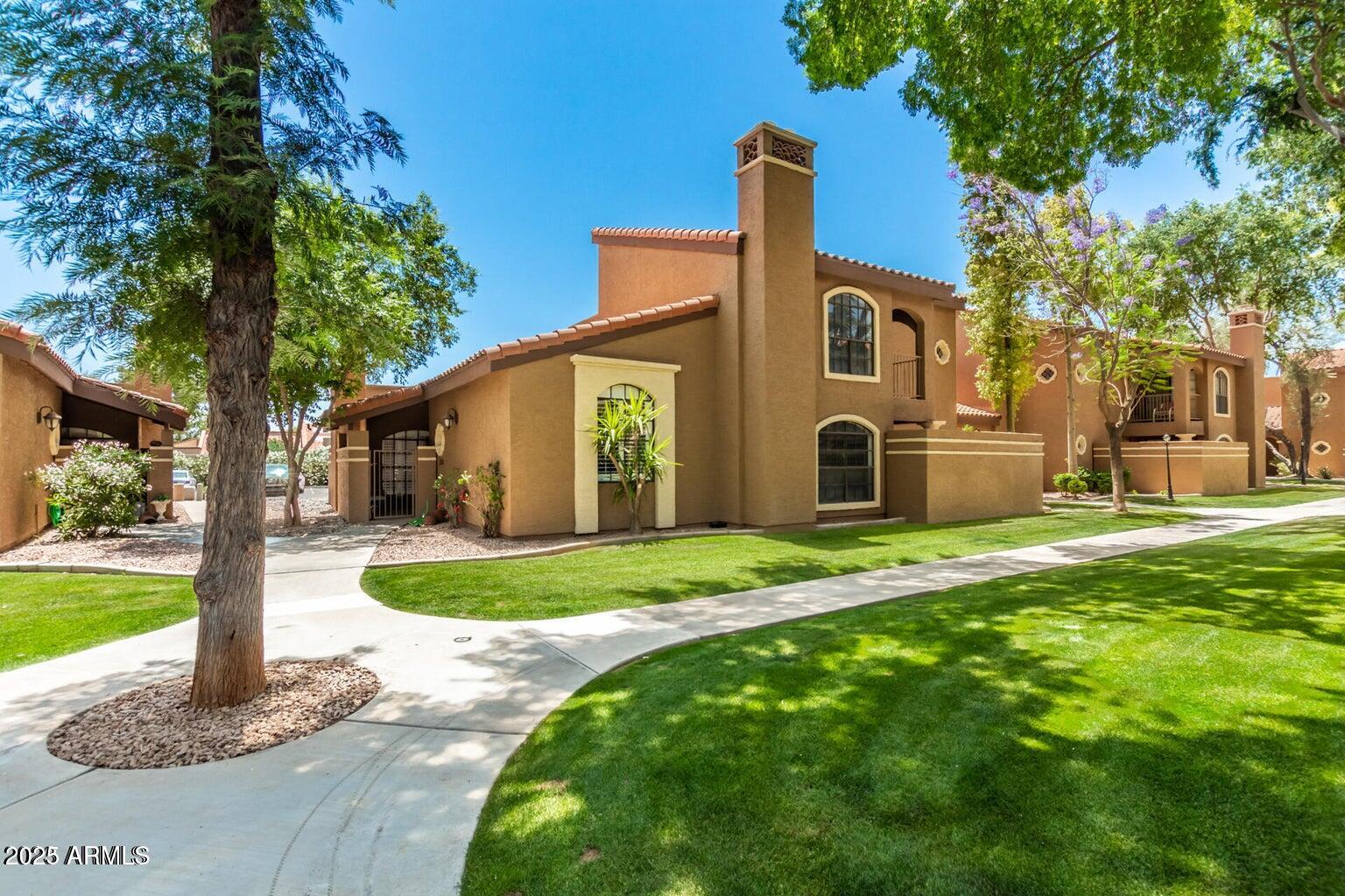 6945 East Cochise Road, Unit 130 Paradise Valley, AZ 85253 - Photo 3 of 24 a front view of a house with garden