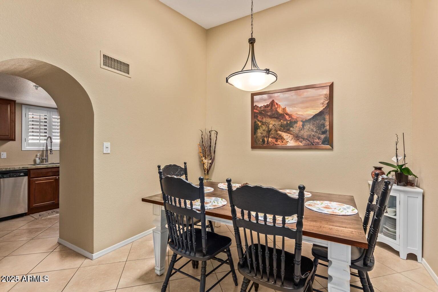 6945 East Cochise Road, Unit 130 Paradise Valley, AZ 85253 - Photo 8 of 24 a view of a dining room with furniture