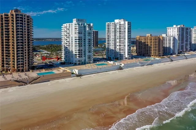 a view of a hallway with wooden floor and a living room