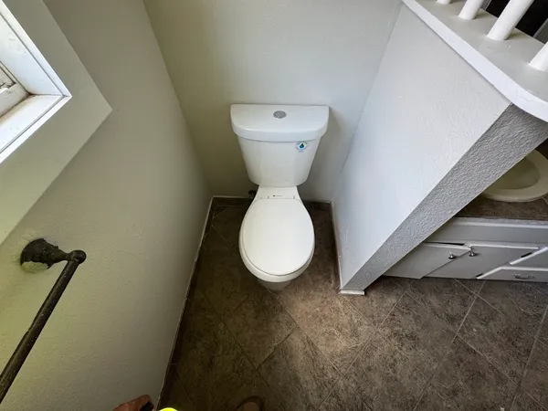 a bathroom with a toilet and a sink