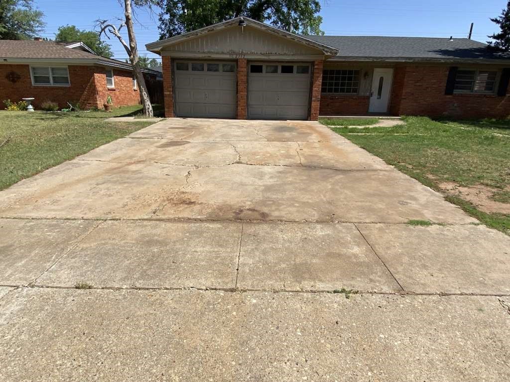 2112 70th Street Lubbock, TX 79412 - Photo 2 of 3 a front view of a house with a garden and yard