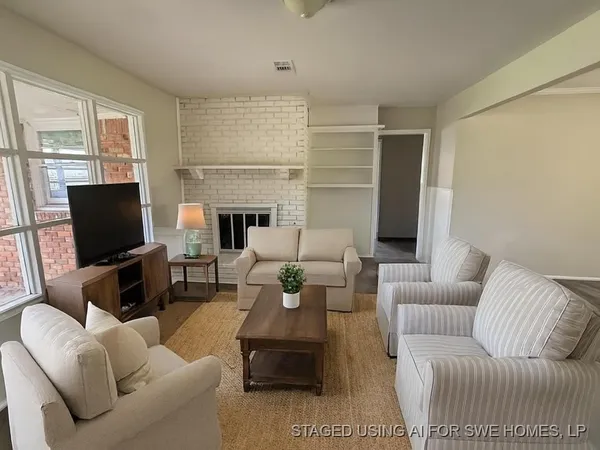 a living room with furniture a fireplace and a flat screen tv