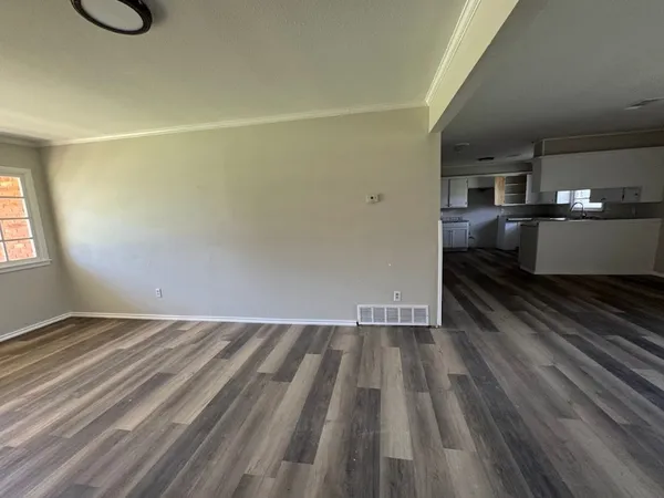 a view of a room with wooden floor