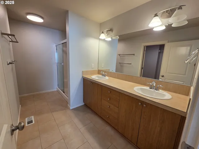 a bathroom with a glass shower door