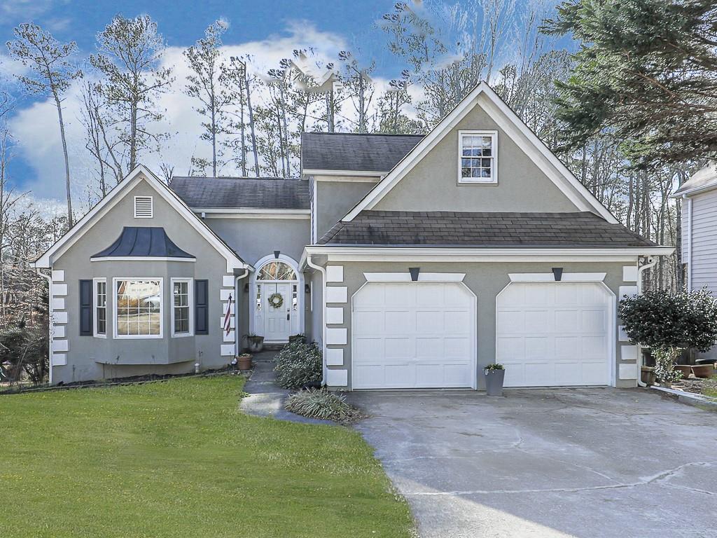 619 Spring Ridge Dr N West Kennesaw, GA 30144 - Photo 1 of 1 a front view of a house with a yard and garage