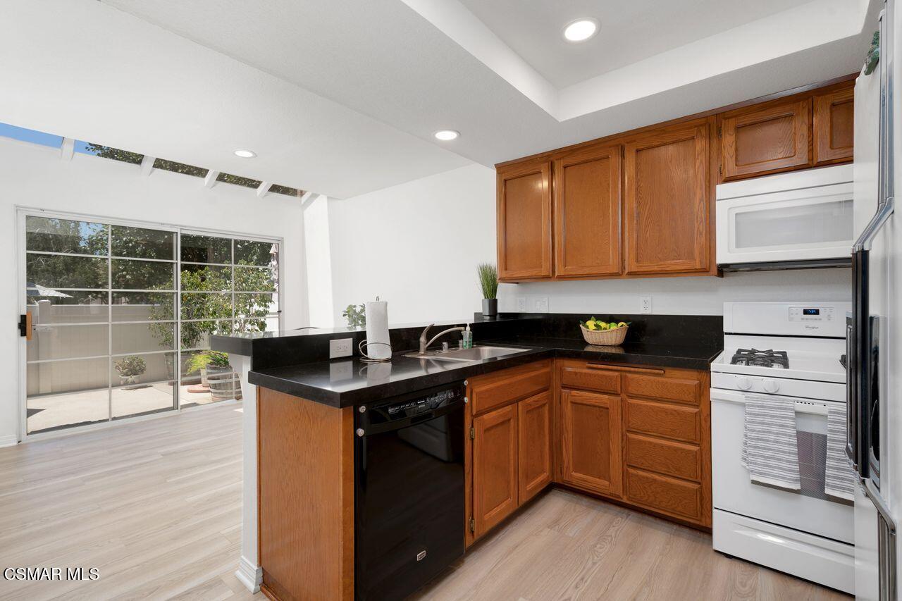 1854 Rory Lane, Unit 4 Simi Valley, CA 93063 - Photo 12 of 37 a kitchen with stainless steel appliances granite countertop a sink stove and refrigerator