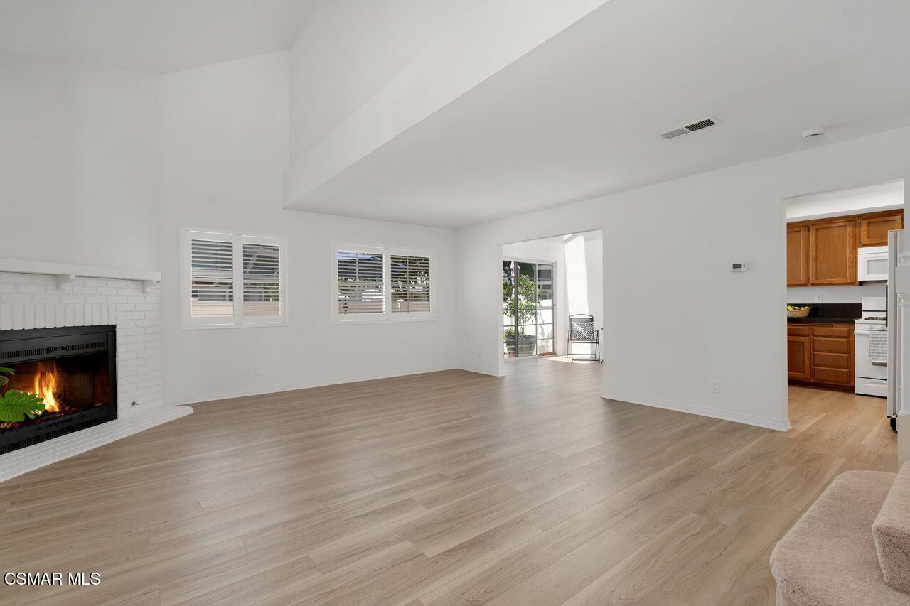 1854 Rory Lane, Unit 4 Simi Valley, CA 93063 - Photo 5 of 37 a view of an empty room with a fireplace and a window