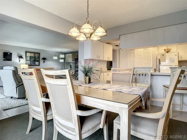 a view of a dining room with furniture and a chandelier