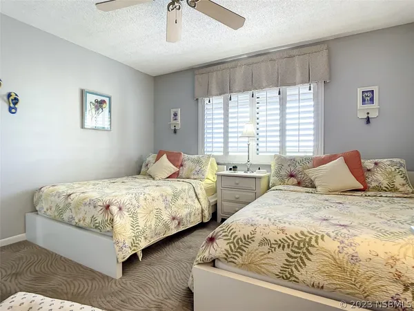 a bedroom with two beds and a window