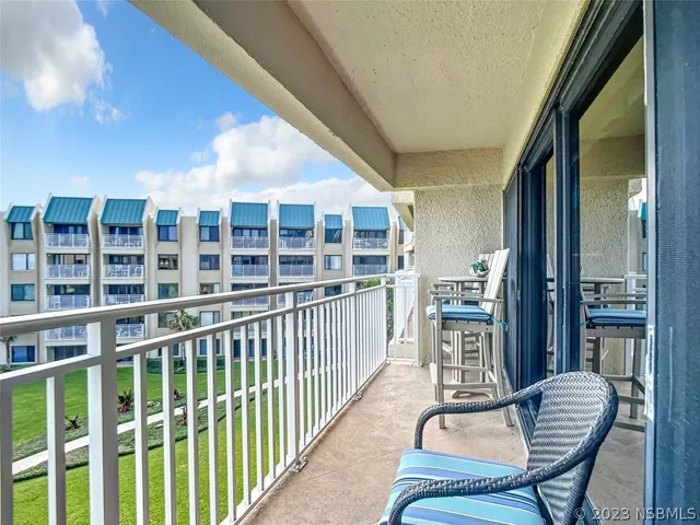 a view of a balcony with chairs