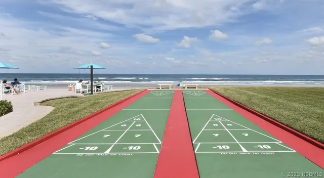a view of a pool with an outdoor space and seating area