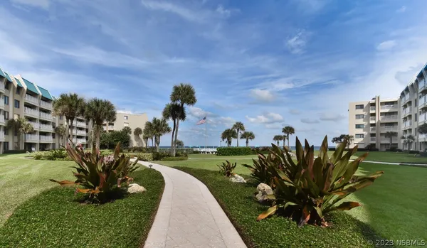 a view of a garden with a building in the background